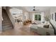 Inviting living room featuring wood floors, a cozy couch, and a staircase leading to the upper level at 7720 Brown Bear Way, Littleton, CO 80125