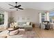 Bright living room featuring a comfortable couch, large windows, and modern decor for a welcoming atmosphere at 7720 Brown Bear Way, Littleton, CO 80125