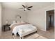 Bright bedroom featuring a ceiling fan, large window, and a cozy bench at 7720 Brown Bear Way, Littleton, CO 80125