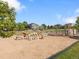 Community park featuring a large playground, sandy play area with dinosaur bone climbers at 7720 Brown Bear Way, Littleton, CO 80125
