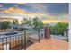 Outdoor wooden balcony overlooking the neighborhood with vibrant sky views at 1052 N Knox Ct, Denver, CO 80204
