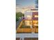 Modern townhome showcasing mixed brick and siding facade, complemented by a private fenced yard at 1052 N Knox Ct, Denver, CO 80204