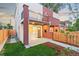 Townhome with a fenced yard and small patio that offers outdoor privacy and enhances curb appeal at 1052 N Knox Ct, Denver, CO 80204