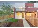 Townhome front entrance featuring a charming entryway, fenced yard, and professional landscaping at 1052 N Knox Ct, Denver, CO 80204