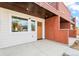 Close up of a modern townhome featuring brick facade, wood door, and covered entry for added curb appeal at 1052 N Knox Ct, Denver, CO 80204