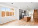 Bright, open kitchen featuring modern appliances, hardwood floors, and an island with pendant lighting at 1052 N Knox Ct, Denver, CO 80204