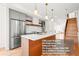 Stylish kitchen featuring stainless steel appliances, ample counter space, and open concept design with nearby staircase at 1052 N Knox Ct, Denver, CO 80204