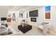 Bright living room with modern furnishings, a fireplace, and an open view to the kitchen at 1052 N Knox Ct, Denver, CO 80204