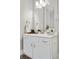 Well-lit bathroom featuring a vanity with ample storage and a large mirror at 3045 Arapahoe St, Denver, CO 80205