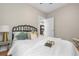 Cozy bedroom with a decorative iron headboard, soft lighting, and a view into the living spaces at 3045 Arapahoe St, Denver, CO 80205