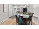 Bright dining area featuring wood floors, a table set for four, and stainless steel appliances in the background at 3045 Arapahoe St, Denver, CO 80205