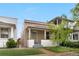 Charming single-story home featuring a cozy front porch with white pillars and a well-manicured lawn at 3045 Arapahoe St, Denver, CO 80205