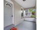 Inviting front porch with painted brick, grey door, and space for seating at 3045 Arapahoe St, Denver, CO 80205