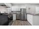 Bright kitchen with stainless steel appliances, granite countertops, and sleek cabinetry at 3045 Arapahoe St, Denver, CO 80205