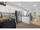 Open concept kitchen with white cabinetry, stainless appliances, and seamless access to other rooms at 3045 Arapahoe St, Denver, CO 80205