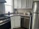 Bright kitchen featuring white cabinets, stainless steel appliances, and granite countertops at 3045 Arapahoe St, Denver, CO 80205