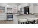 Eat-in kitchen features granite counters, a gas range, stainless steel appliances and white cabinets at 3045 Arapahoe St, Denver, CO 80205