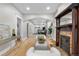 Elegant living room with hardwood floors, a decorative fireplace, and an open floor plan leading to the dining area at 3045 Arapahoe St, Denver, CO 80205