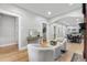 Open-concept living room featuring hardwood floors, comfortable seating, and views of the dining and kitchen areas at 3045 Arapahoe St, Denver, CO 80205