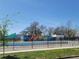 Outdoor public pool area with a colorful mural in the background, enclosed by a black metal fence at 3045 Arapahoe St, Denver, CO 80205