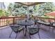 Inviting covered back deck area with outdoor seating and views of the surrounding trees at 8316 Green Island Cir, Lone Tree, CO 80124