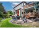 Backyard patio with firepit and outdoor seating, complemented by upper-level deck at 8316 Green Island Cir, Lone Tree, CO 80124