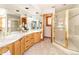 Spacious bathroom with dual vanities, shower and plentiful mirrors at 8316 Green Island Cir, Lone Tree, CO 80124