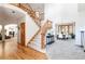 Spacious foyer with a curved staircase, hardwood floors, and an arched entrance to the dining room at 8316 Green Island Cir, Lone Tree, CO 80124