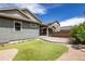 This beautiful backyard features lush artificial turf and a charming stone patio area at 15392 W 49Th Ave, Golden, CO 80403
