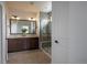 Bathroom featuring a glass shower, double vanity, and a large mirror at 15392 W 49Th Ave, Golden, CO 80403