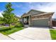 Attractive single-Gathering home showcasing a well-kept lawn, stone details, and a two-car garage at 15392 W 49Th Ave, Golden, CO 80403