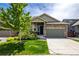 Charming single-Gathering home featuring a manicured lawn, stone accents, and a two-car garage at 15392 W 49Th Ave, Golden, CO 80403