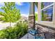 Comfortable porch area with view of the street, lush landscaping, and stone pillars at 15392 W 49Th Ave, Golden, CO 80403