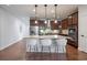 Bright kitchen featuring stainless steel appliances, a large island with seating, and dark wood cabinets at 15392 W 49Th Ave, Golden, CO 80403