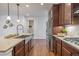 Spacious kitchen with stainless steel appliances, dark cabinets, and a large stainless steel sink and faucet at 15392 W 49Th Ave, Golden, CO 80403