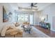 Cozy living room featuring a comfortable sofa, stylish decor, and a ceiling fan for a relaxing atmosphere at 15392 W 49Th Ave, Golden, CO 80403