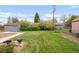 Lush backyard featuring well-maintained lawn, mature trees, and serene ambiance, perfect for outdoor activities at 3202 S Dahlia St, Denver, CO 80222
