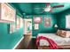 Large bedroom with wood floors, ceiling fan, colorful walls, bed, vintage decor, and artistic vibe at 3202 S Dahlia St, Denver, CO 80222