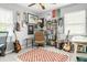 Bedroom with electric and acoustic guitars, modern chair, patterned rug, and ceiling fan at 3202 S Dahlia St, Denver, CO 80222