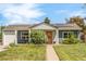 Charming single-story home with blue siding, solar panels, a well-manicured lawn, and a welcoming front porch at 3202 S Dahlia St, Denver, CO 80222