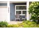 Inviting front porch with comfortable gray seating, perfect for enjoying the outdoors at 3202 S Dahlia St, Denver, CO 80222