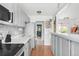 Well-lit kitchen with gray cabinets, stainless steel appliances, and hardwood floors for a modern look at 3202 S Dahlia St, Denver, CO 80222