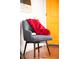 Cozy reading nook with a comfortable chair and a colorful blanket, lit by natural light at 3202 S Dahlia St, Denver, CO 80222