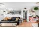 Bright living room with a view of the modern kitchen, featuring hardwood floors and neutral colors at 3202 S Dahlia St, Denver, CO 80222