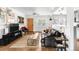 Open-concept living room with a comfortable sofa, stylish decor, and a vibrant orange front door at 3202 S Dahlia St, Denver, CO 80222