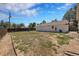 Fenced backyard features a detached garage, sunny skies and mature trees, offering privacy and outdoor enjoyment at 2226 Fulton St, Aurora, CO 80010