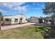 Spacious backyard with grass lawn, detached garage, and covered patio at 2226 Fulton St, Aurora, CO 80010