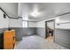 Basement room featuring gray wainscoting, a window, and carpeting at 2226 Fulton St, Aurora, CO 80010