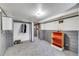 Basement with gray wainscoting, closet, and doorway leading to another room at 2226 Fulton St, Aurora, CO 80010