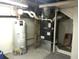 View of basement with water heater and Goodman furnace system at 2226 Fulton St, Aurora, CO 80010
